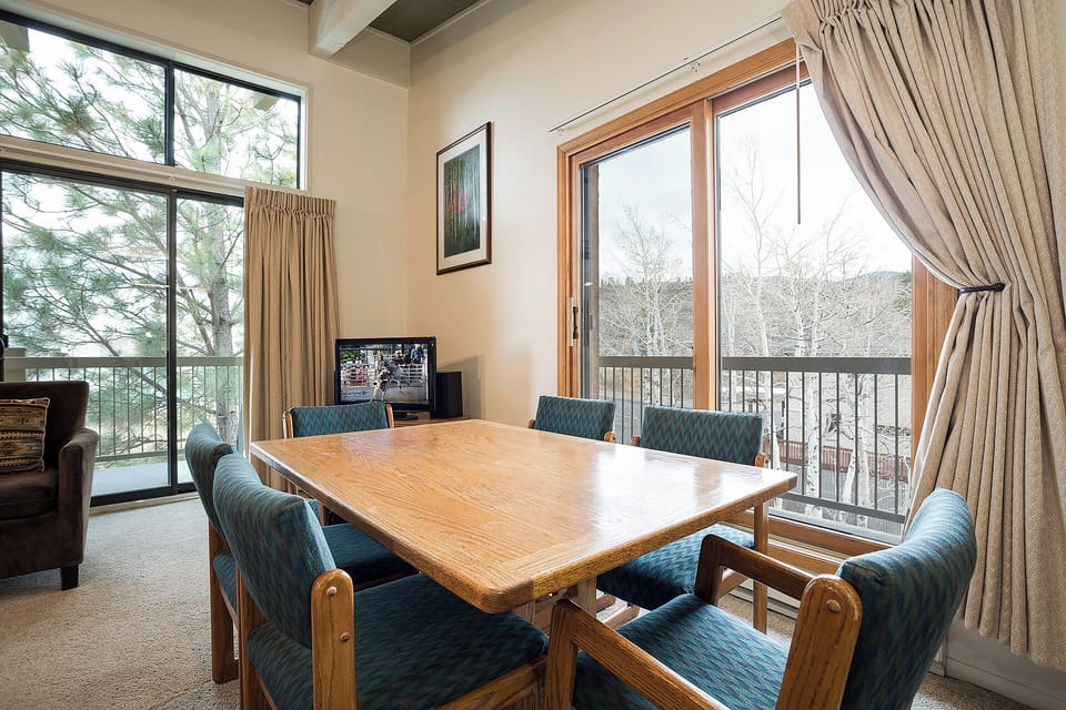 Gather around your dining table for meals with mountain views through floor-to-ceiling windows, then step onto your private balcony to enjoy the fresh air.