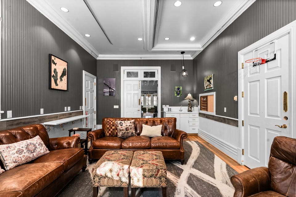 The den off of the grand room with a smart TV, puzzles, board games & fireplace