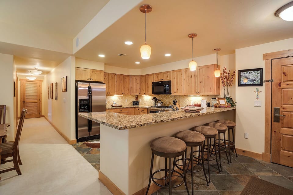 Your spacious gourmet kitchen awaits with granite counters, stainless steel appliances, and a welcoming breakfast bar where you can gather with friends and family for coffee or meals.