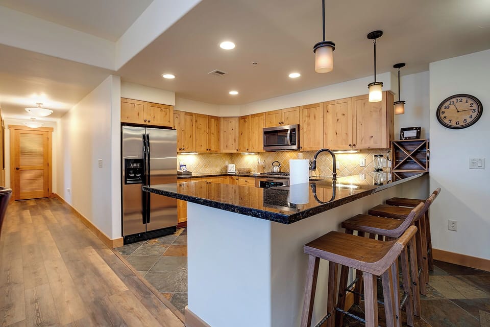 You'll love cooking in this open kitchen with granite counters, stainless appliances, and a welcoming breakfast bar perfect for morning coffee or evening conversation.
