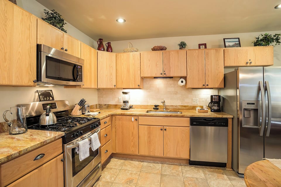 Your fully equipped kitchen features stainless steel appliances, granite countertops, and ample cabinet space—perfect for preparing memorable meals during your stay.