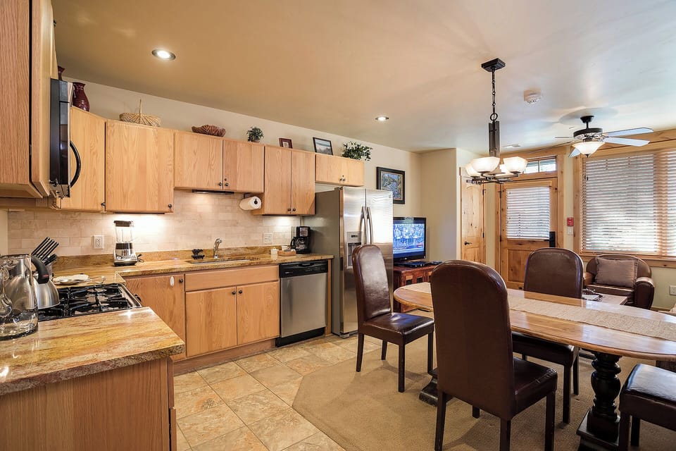 Gather around your spacious kitchen and dining area—fully equipped with granite counters, stainless appliances, and plenty of room to cook, eat, and unwind together after your adventures.