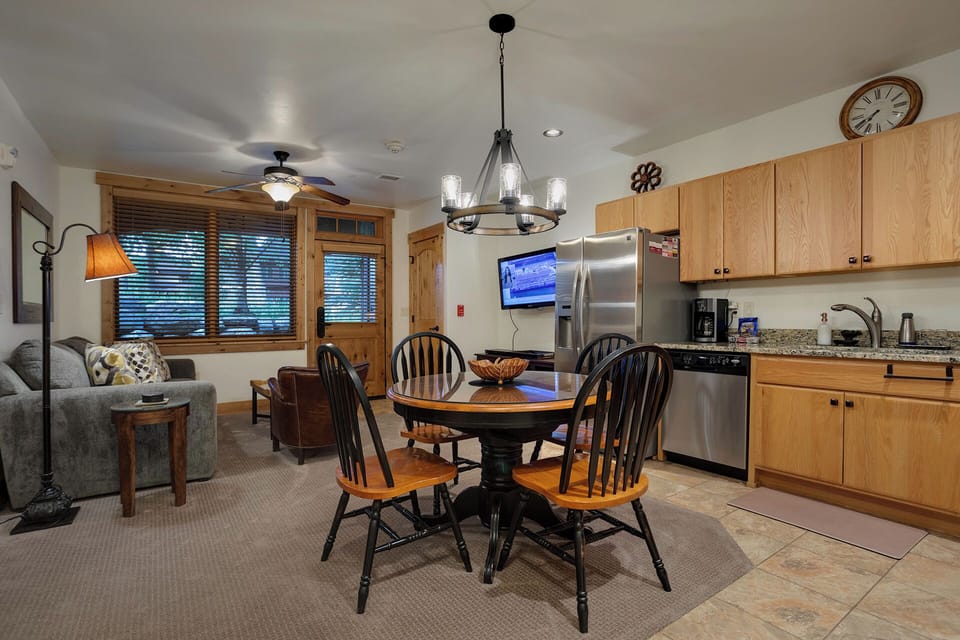 Gather around the dining table in this cozy open-concept space where kitchen, living, and dining blend seamlessly—perfect for your group meals and evenings relaxing together.