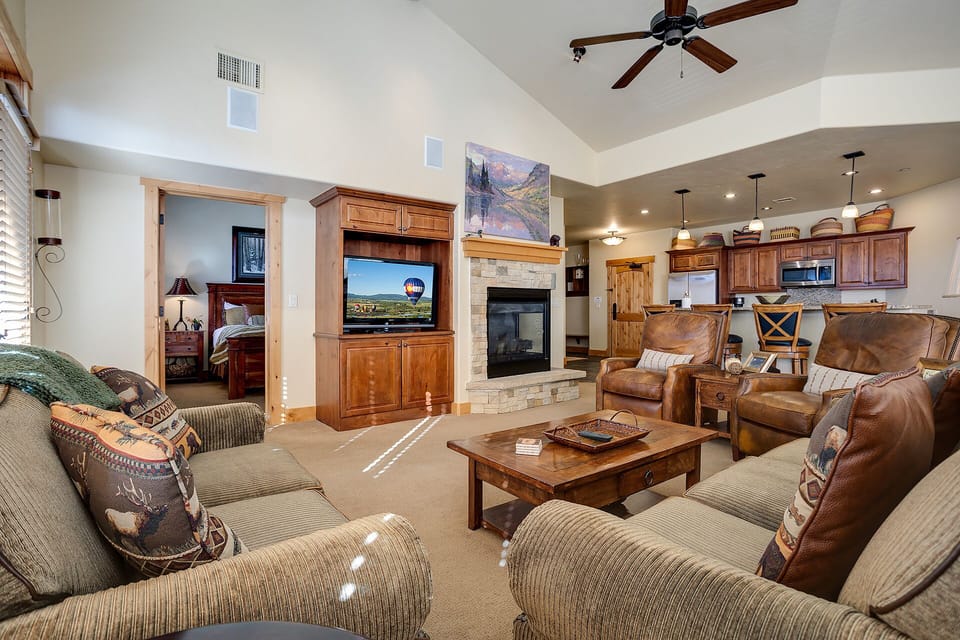 Settle into plush seating around the stone fireplace, where your favorite shows await on the flat-screen TV and open sightlines to the kitchen make gathering effortless.