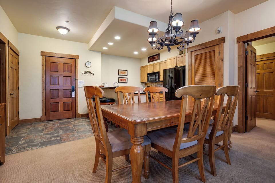 Gather around this spacious dining table where your group can share meals, stories, and laughter together. The adjoining kitchen makes serving effortless, creating the perfect spot for memorable evenings.