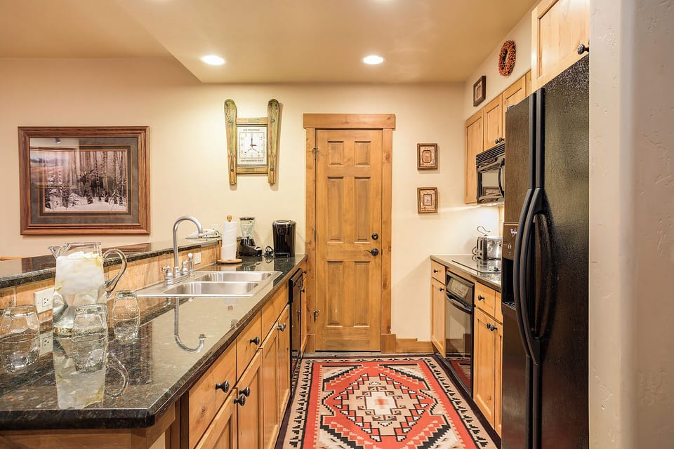 Step into your well-equipped kitchen, featuring granite counters, stainless appliances, and mountain-inspired décor. Everything you need to prepare your favorite meals awaits in this warm, inviting space.
