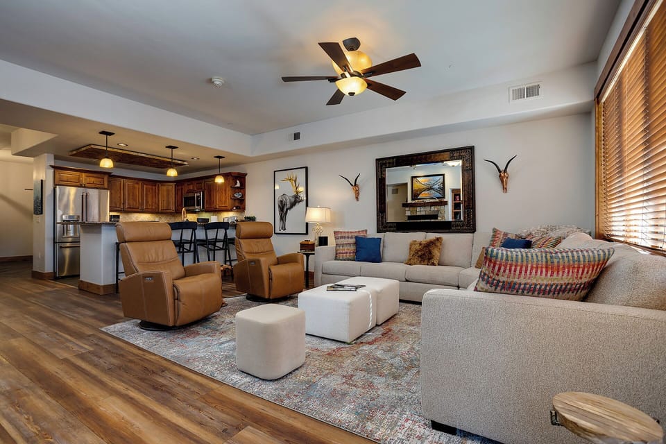 Stretch out on plush seating in your open-concept living space, where warm wood tones and southwestern accents create a welcoming retreat after your adventures.