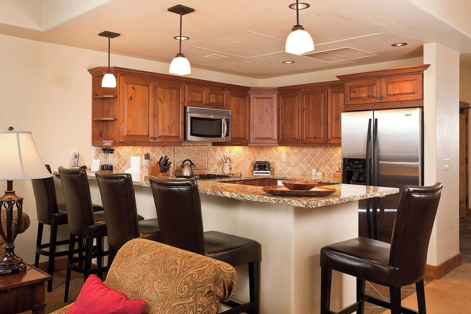 Your gourmet kitchen awaits with rich cabinetry, granite countertops, and stainless appliances. Perfect for preparing meals together at the breakfast bar.
