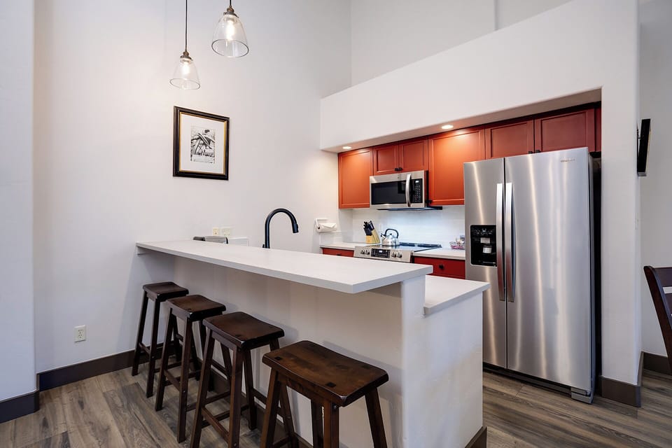 Step into your spacious kitchen with a generous breakfast bar and modern stainless steel appliances ready for your culinary adventures.