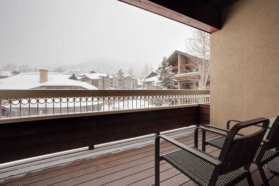 Step onto your private balcony and breathe in the crisp mountain air while gazing at snow-dusted rooftops and distant peaks—your peaceful winter retreat awaits.