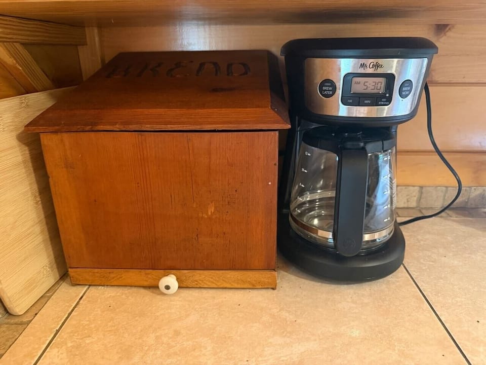 Coffee maker and storage box, conveniently set up for your morning brew.