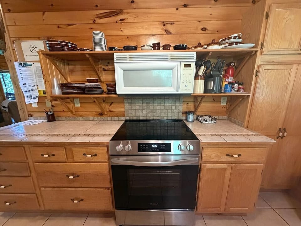 Fully equipped kitchen with ample storage, cookware, and modern appliances.