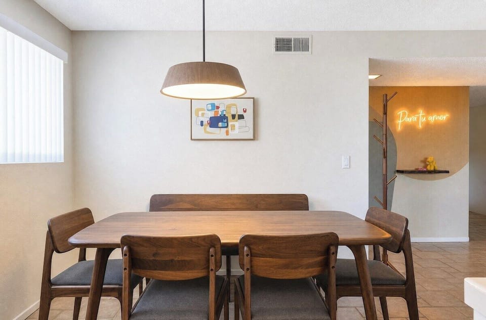 Gather around this beautiful wooden dining table beneath a warm pendant light—perfect for sharing meals and making memories together during your stay.