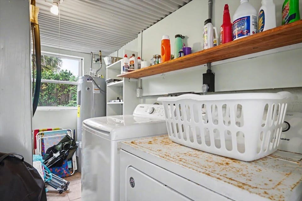 Laundry area with washer, dryer, utility sink and storage shelf