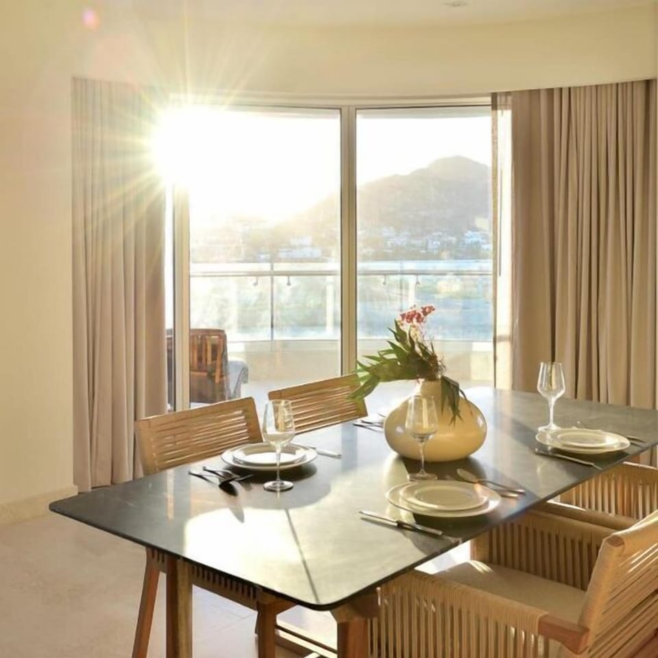 Sunlit dining space with balcony access and beautiful mountain views