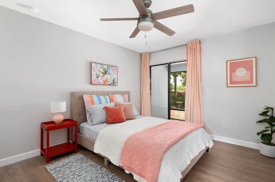 Guest Bedroom with tropical view opens to screened patio and outdoor space.