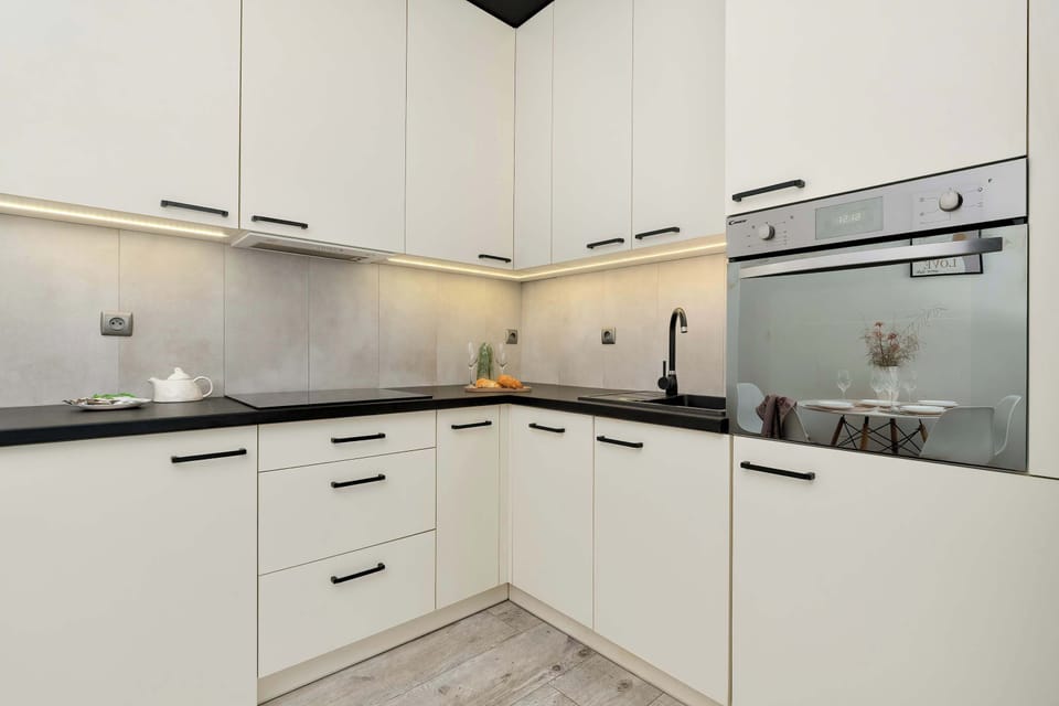 The sleek design of the kitchenette blending seamlessly with the living area.