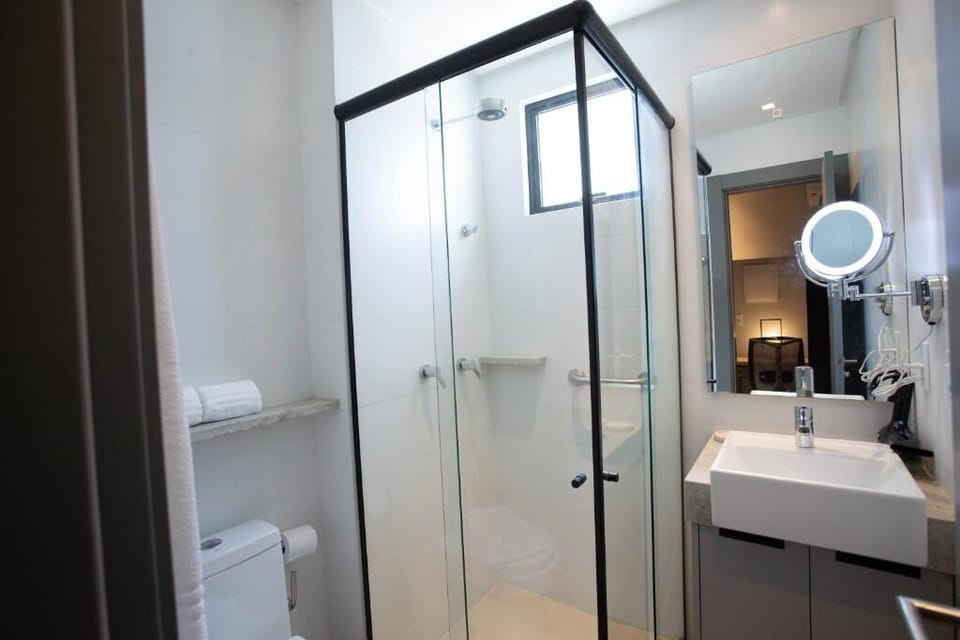 Refresh in a bright, spotless bathroom with glass-enclosed shower.