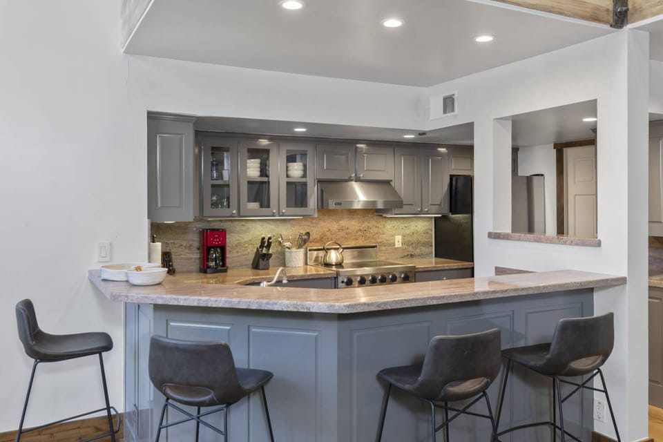 Dining room: Dining table with seating for 8 guests and adjacent breakfast bar with 4 barstools

