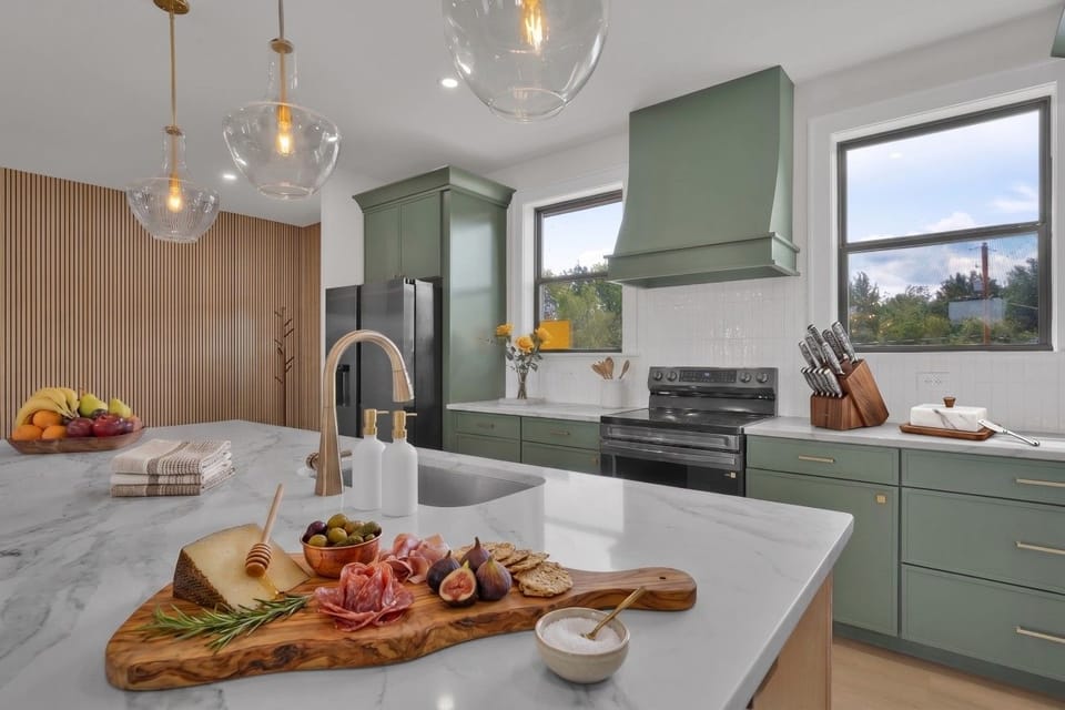 A spacious kitchen island with an integrated dishwasher and microwave, offering added convenience and plenty of room for meal prep, serving, and gathering.