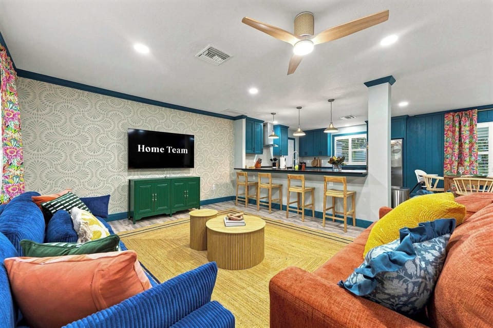 From the couch to the counter, conversation flows easy in this open layout. Whoever's cooking never misses a moment with the group.