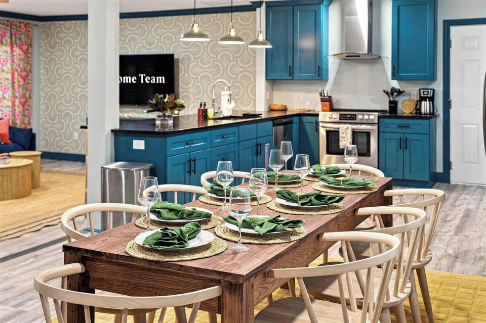 Plates set, glasses out, dinner nearly ready — this dining space puts everyone within arm's reach of the kitchen so no one misses a minute of the meal.