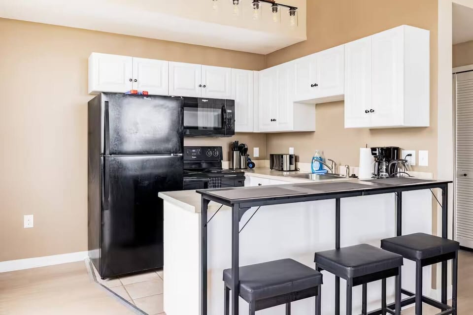 Fully equipped kitchen with the essentials—full-size appliances, coffee maker, cookware, and spacious counter seating—ideal for preparing meals during short or extended stays.