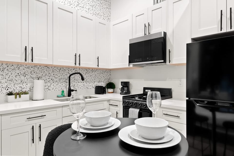 🍽️ Bold mosaic tile and black cabinetry—a kitchen with real personality, made for cooking in style.