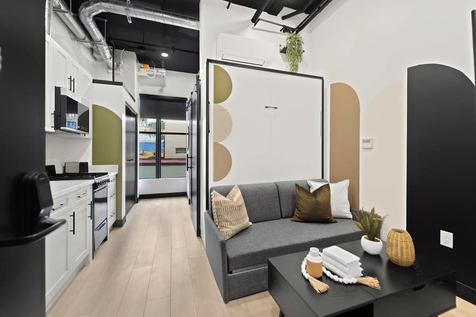 🖤 Modern lines meet warm tones—a compact living area designed to feel bigger than it is.