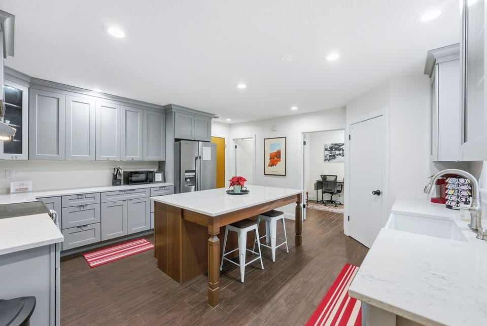 This pet friendly Fort Wayne mansion features a seamless kitchen layout with quick backyard access so you can easily let your pup out to play.