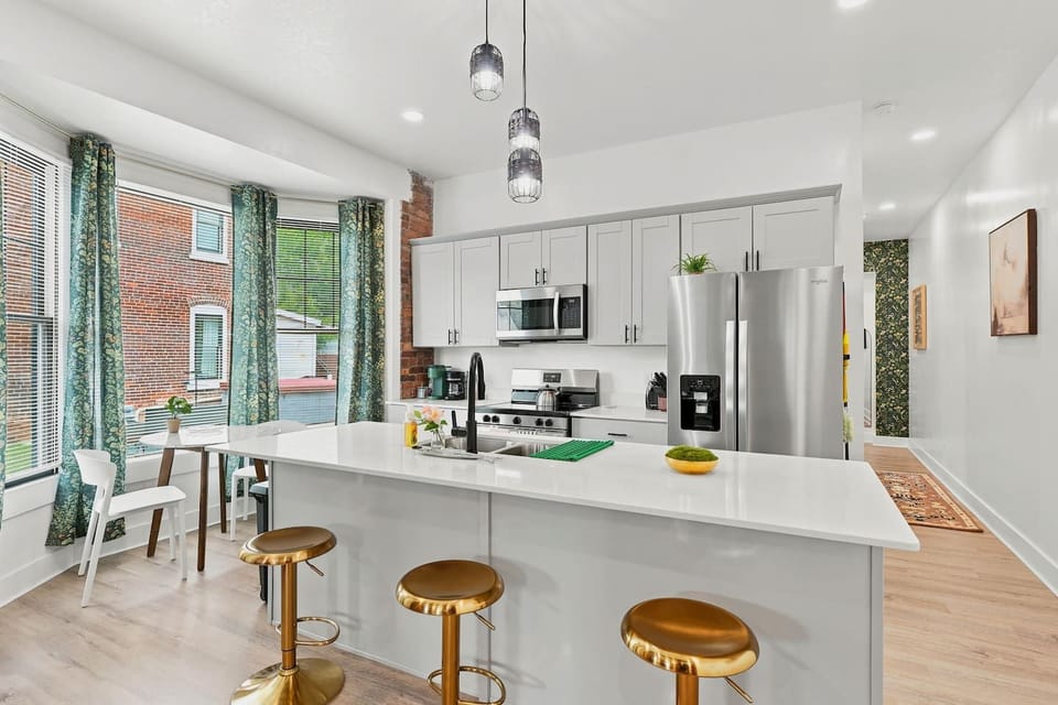 Bright open kitchen featuring quartz island seating for three. Ideal for light meals before hitting local Fort Wayne sights like Science Central.
