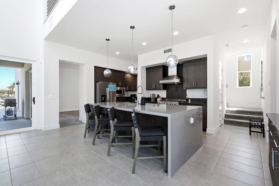 Kitchen leads to second floor living room, guest bedroom & full bath. 