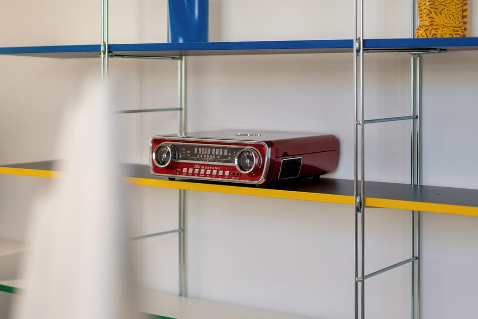 Glass shelves display colorful decorations and give the room a modern appearance.