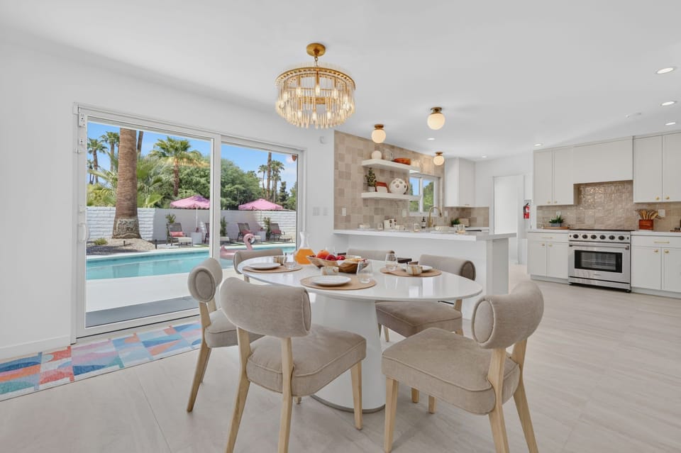 Open-concept dining and kitchen area with direct access to the backyard through sliding glass doors, creating an easy indoor-outdoor flow for shared meals, morning coffee, and evenings together.