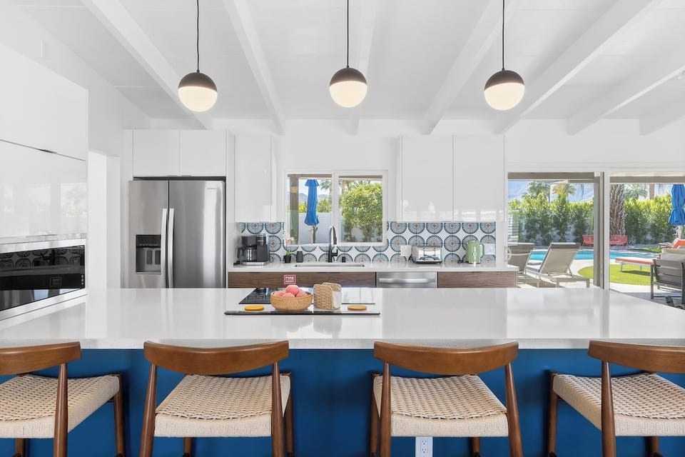 Your stunning kitchen features gleaming countertops, modern appliances, and stylish pendant lighting, creating the perfect space for memorable meals together.