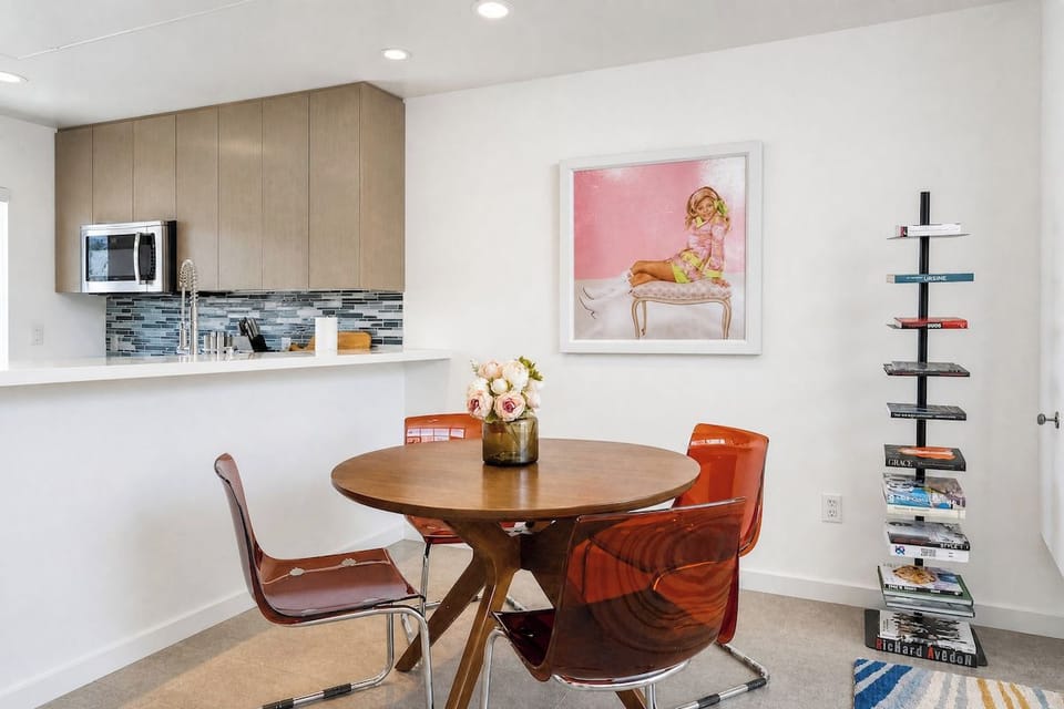 Your open-concept dining area flows seamlessly into a modern kitchen, perfect for intimate meals or casual gatherings with stylish seating and plenty of counter space.