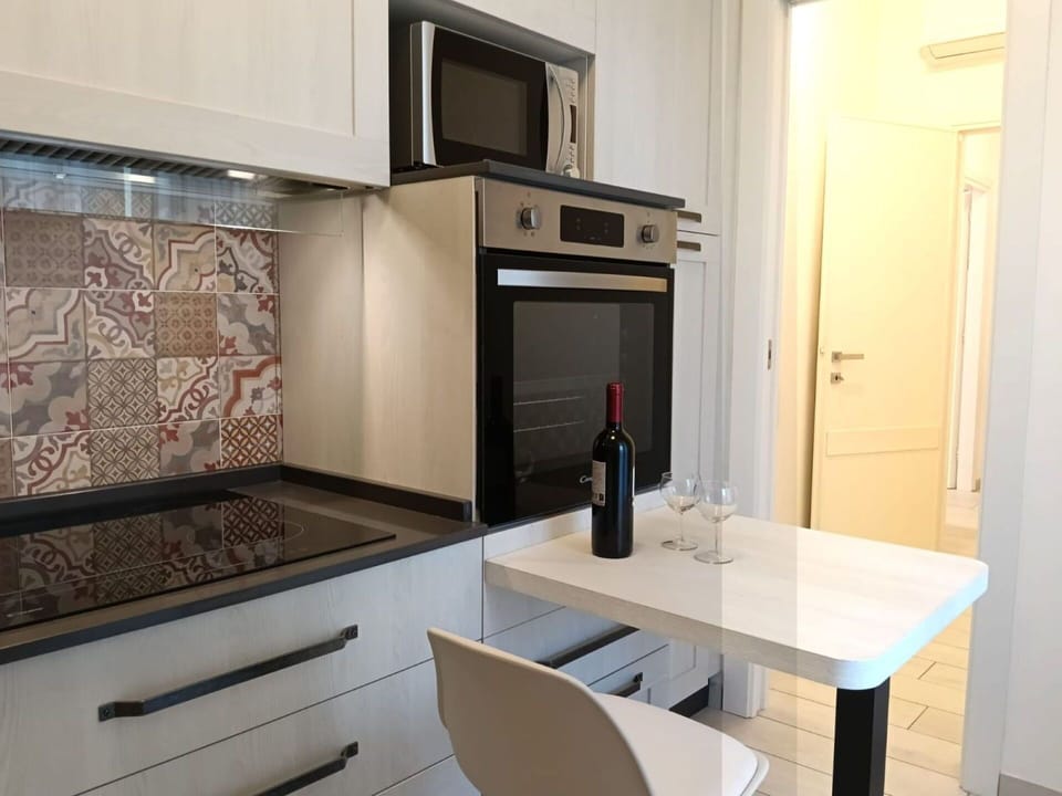 Flooring, Interior Design, Kitchen, Countertop, Floor, Kitchen Appliance, Major Appliance, Furniture, Cabinetry, Room