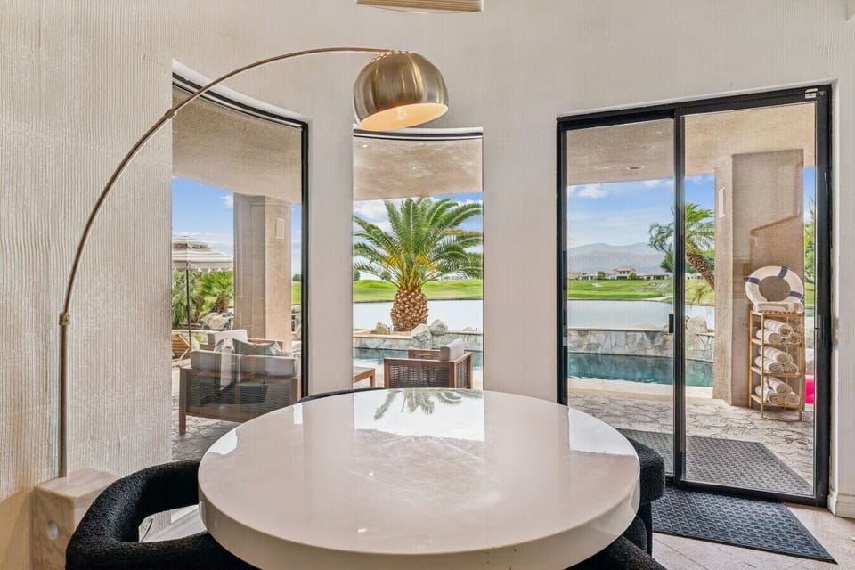 Dining space overlooking the pool and outdoor oasis