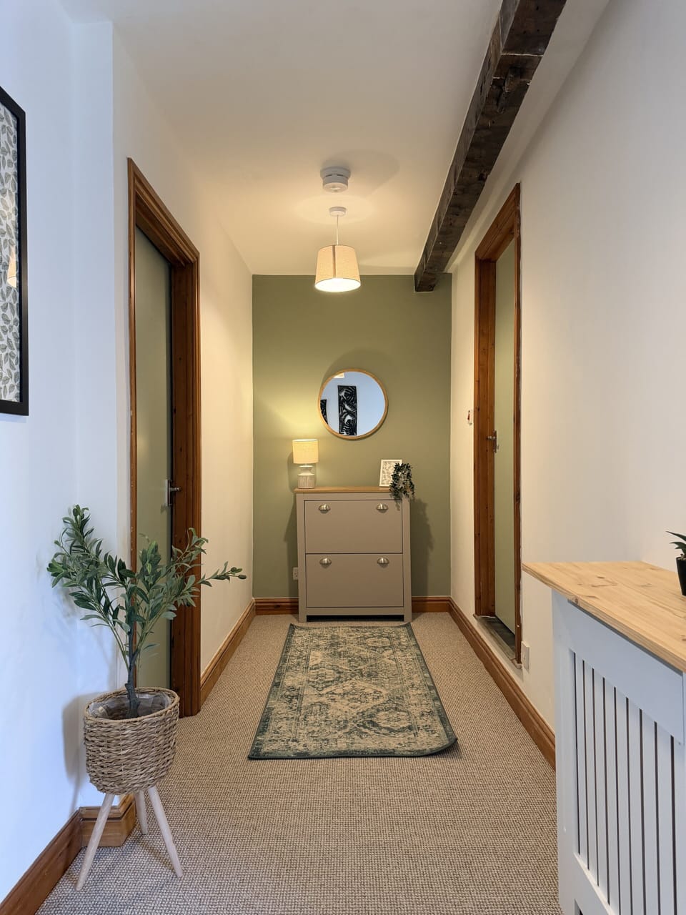 Charming entry hall with rustic beams, soft lighting, and stylish decor