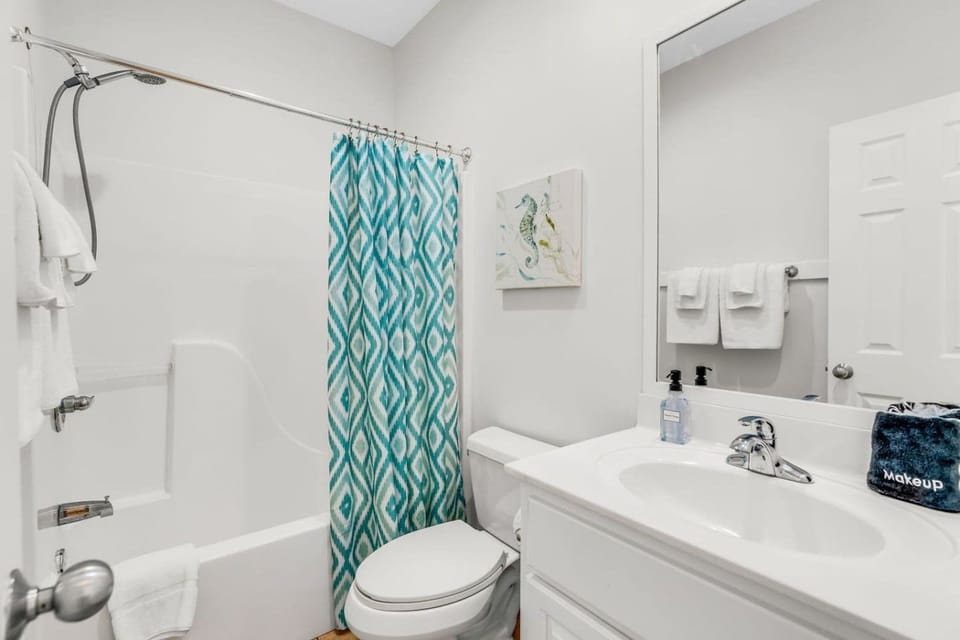 Fresh coastal decor makes even the bathrooms feel like part of the beach experience.