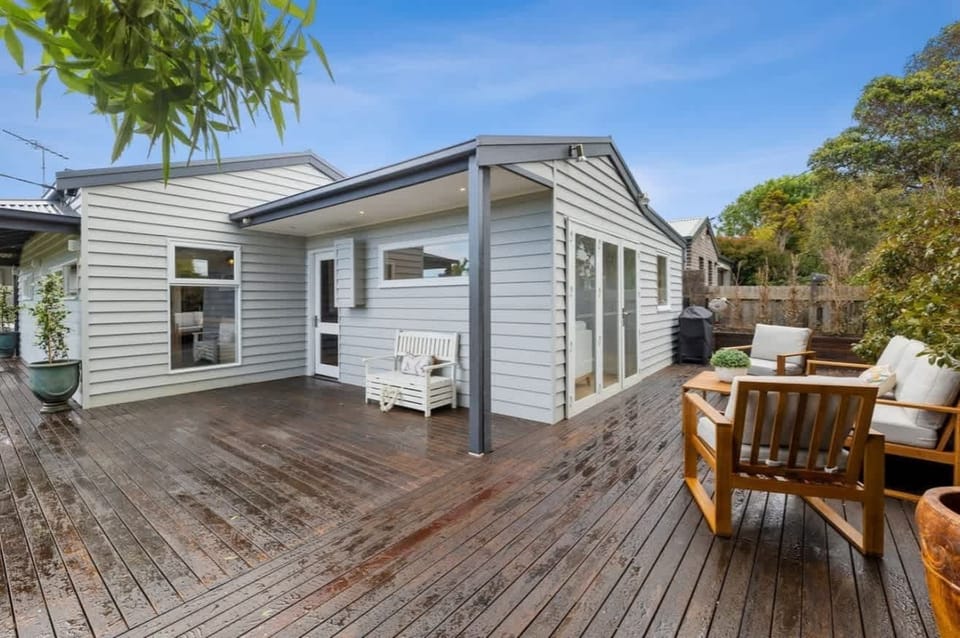 Large fully fenced front yard with BBQ, play equipment, fire pit, deck with outdoor furniture and gorgeous lawns. This yard is great for pets and kids alike!