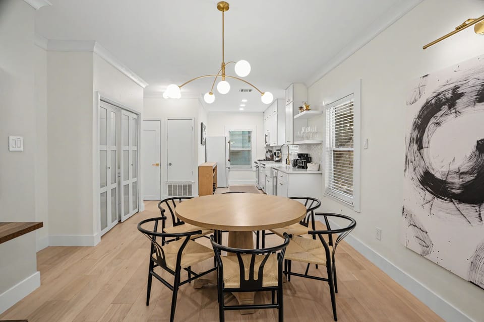 Bright modern dining space with stylish seating and open kitchen