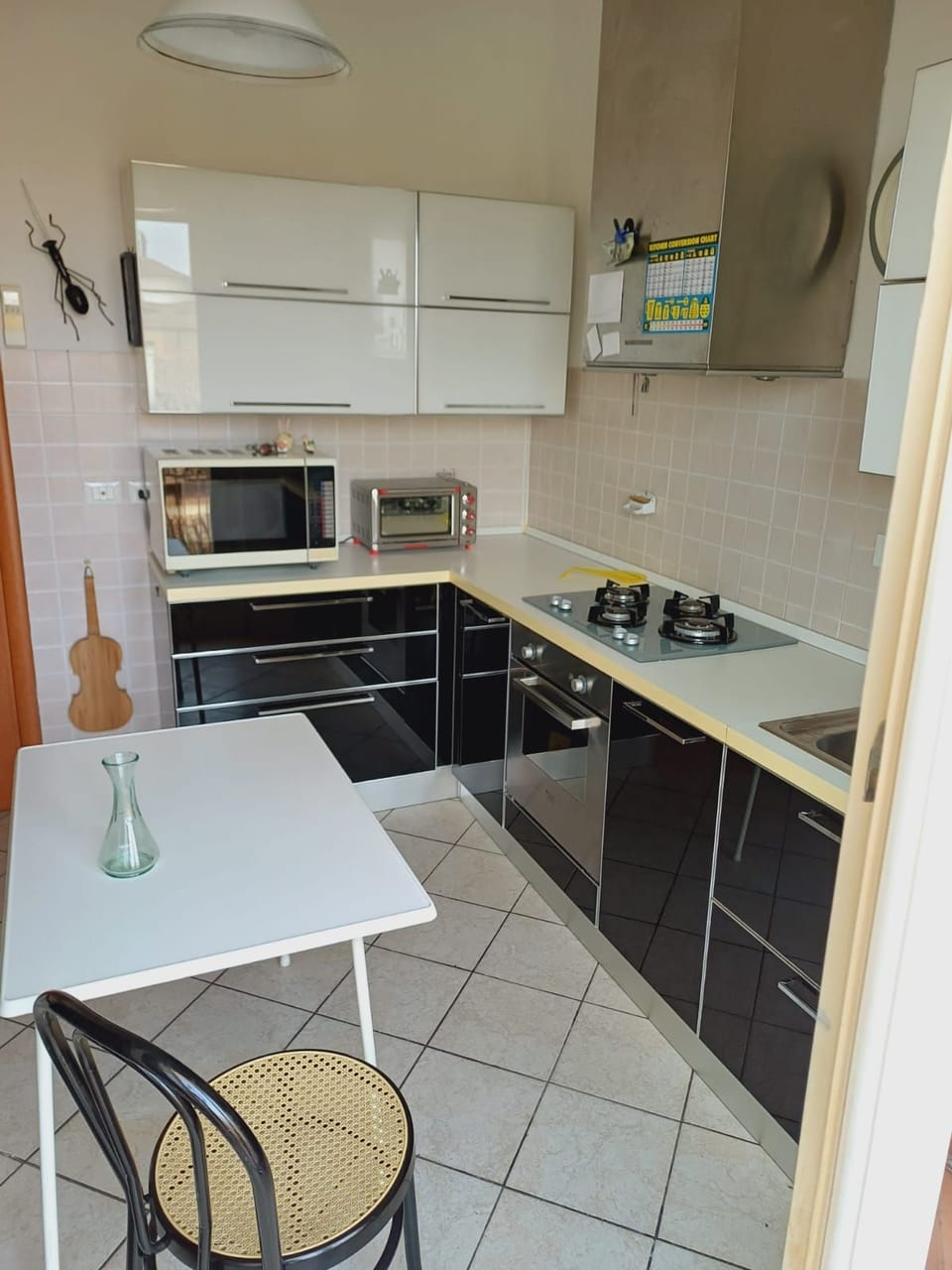 Full size eat in kitchen with table and a full size refrigerator freezer. 