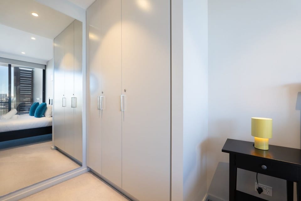 A bright and peaceful bedroom with generous storage and a warm, inviting feel, providing a comfortable place to relax and settle in.