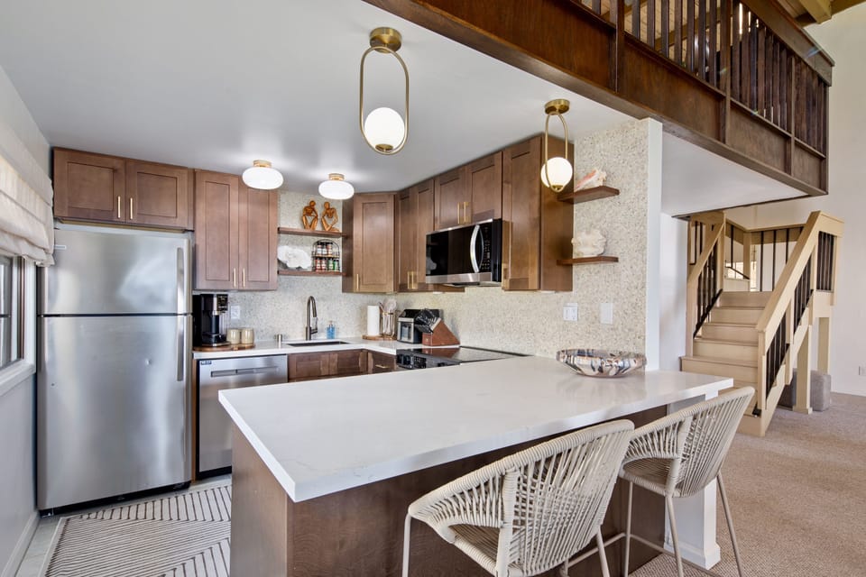 A full kitchen with island seating, so someone always ends up perched while dinner comes together.