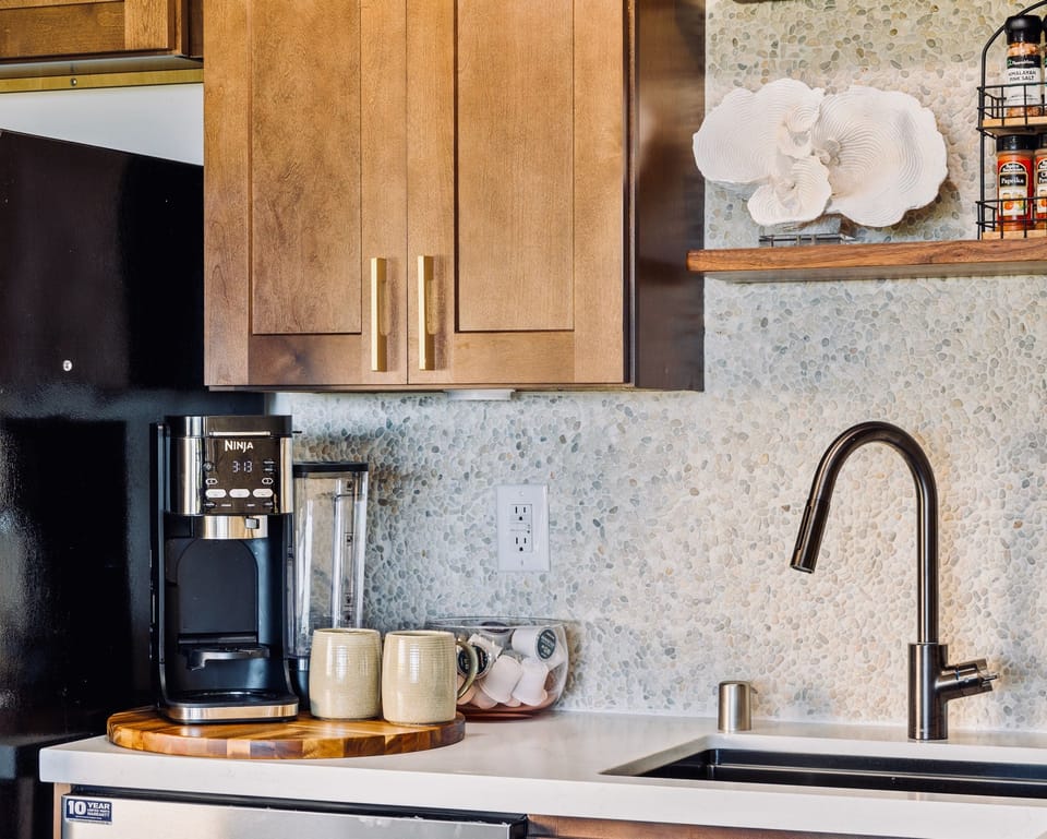 Coffee is handled, mugs already out beside the sink before anyone wakes up.