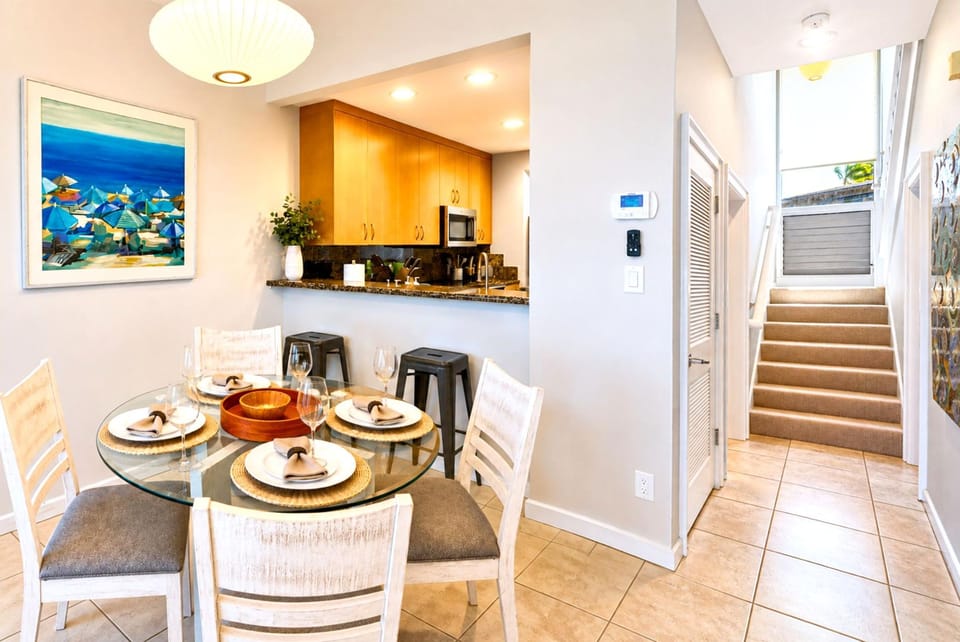 Enjoy movie nights from your comfortable living area, complete with a large TV and bright coastal surroundings.