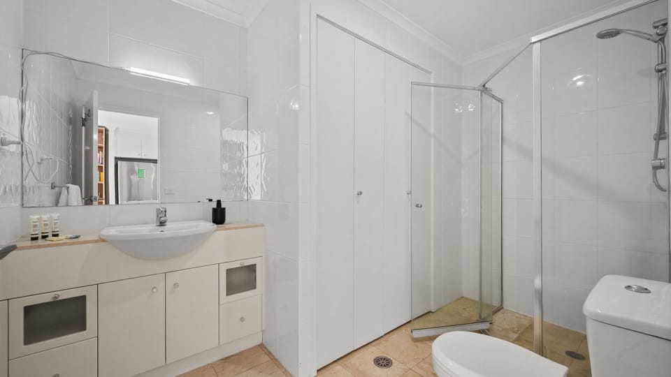 Large bathroom and spacious glass-enclosed shower.