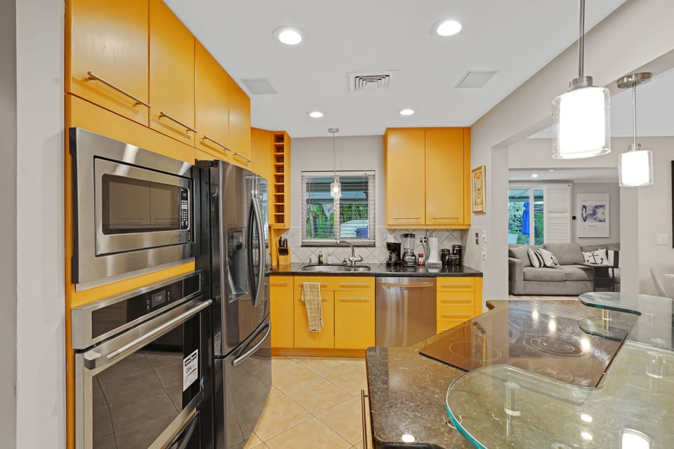 Open kitchen with a center island, abundant cabinetry, and easy access to the dining area.