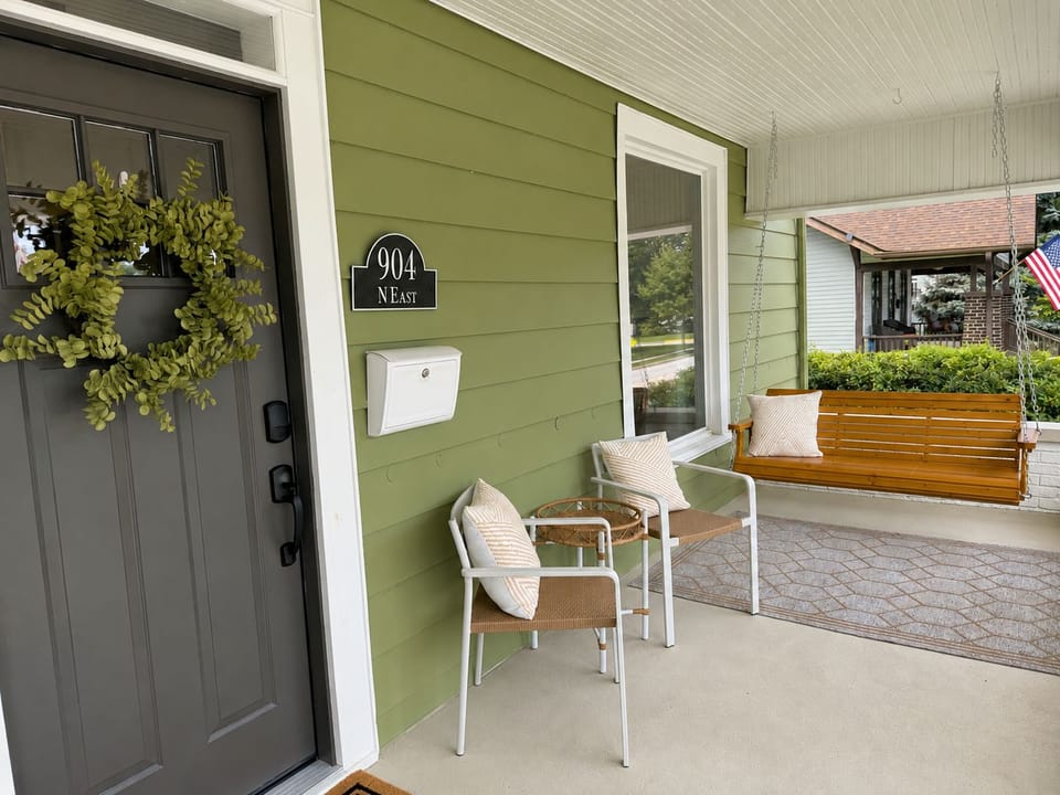 Charming covered front porch with cozy seating and a relaxing swing